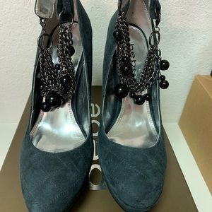 Gray suede pumps with decorative ankle strap.